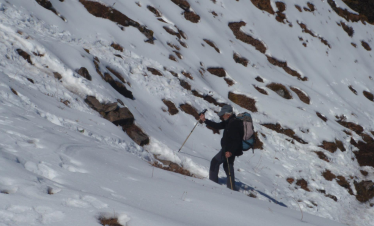 Trekkers approaching Makalu Base Camp with dramatic glaciers and the towering Makalu massif.