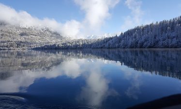 Rara Lake Trek with crystal-clear lake, surrounding Himalayan peaks, and lush forests in Nepal
