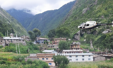helicopter flying over Langtang Himalayan peaks with snow-capped mountains, green valleys, and a river below.