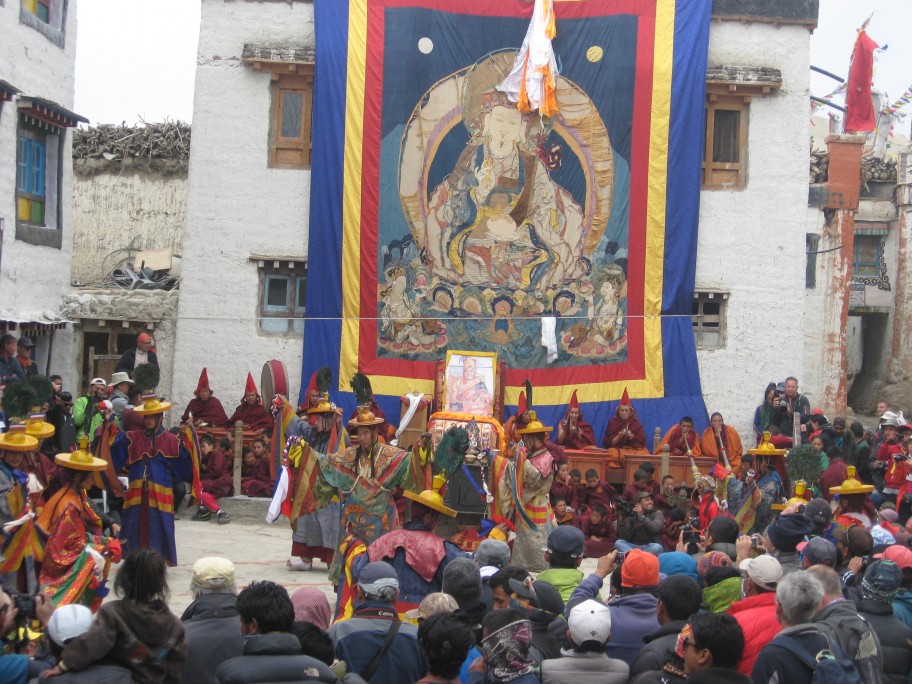 The snow-capped peak of Mount Kailash in Tibet under a clear blue sky, surrounded by colorful prayer flags during the Saga Dawa festival.