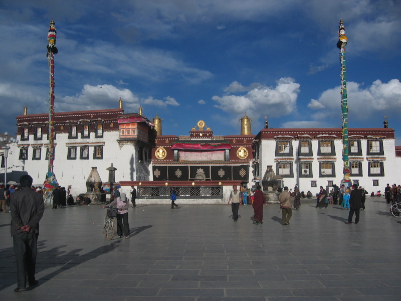 Sacred Charm of Jokhang Temple 2026 with golden rooftop, Tibetan architecture, and colorful prayer flags in Lhasa