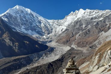 Stunning view of Langtang Lirung snow-capped peaks under clear blue sky.