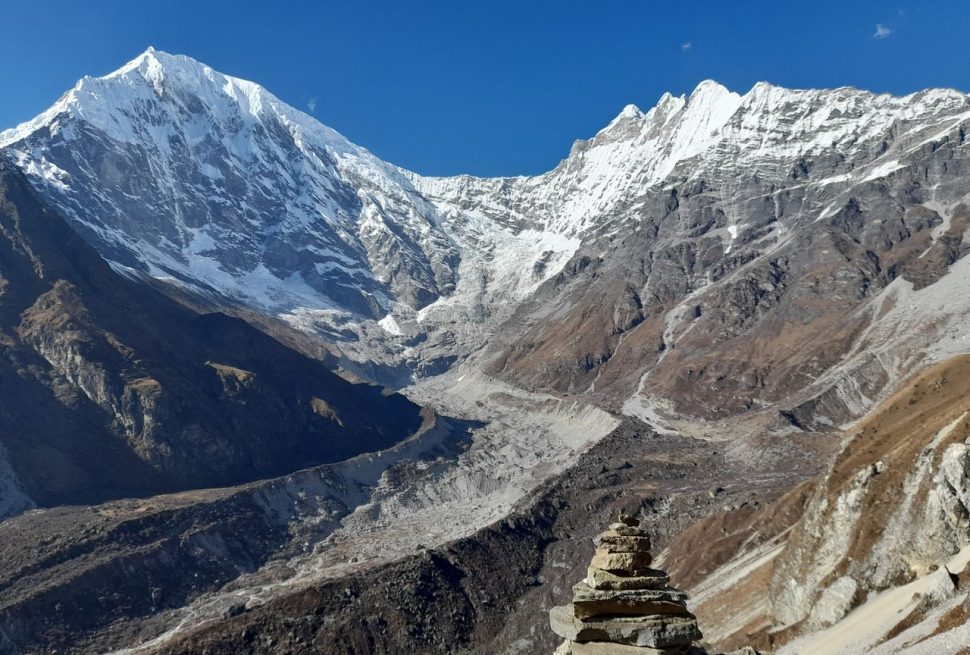 Stunning view of Langtang Lirung snow-capped peaks under clear blue sky.