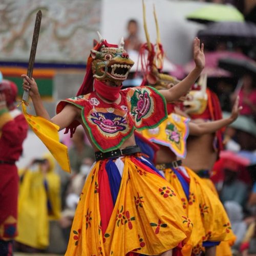 Colorful and traditional Bhutanese dance performance with vivid costumes and masks, showcasing cultural heritage.