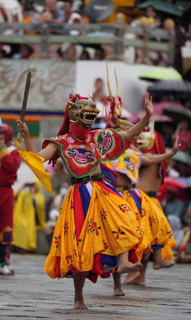 Colorful and traditional Bhutanese dance performance with vivid costumes and masks, showcasing cultural heritage.